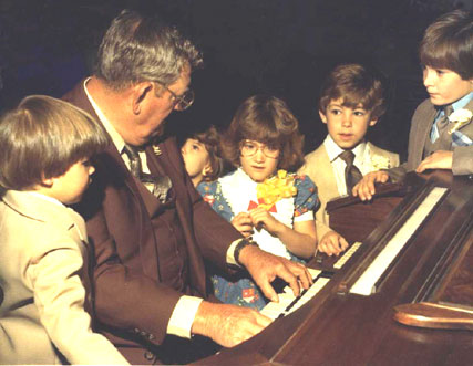 Marvin playing for his great grandchildren, 1982