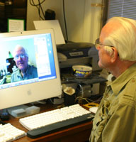 Larry Knowles seated at his computer